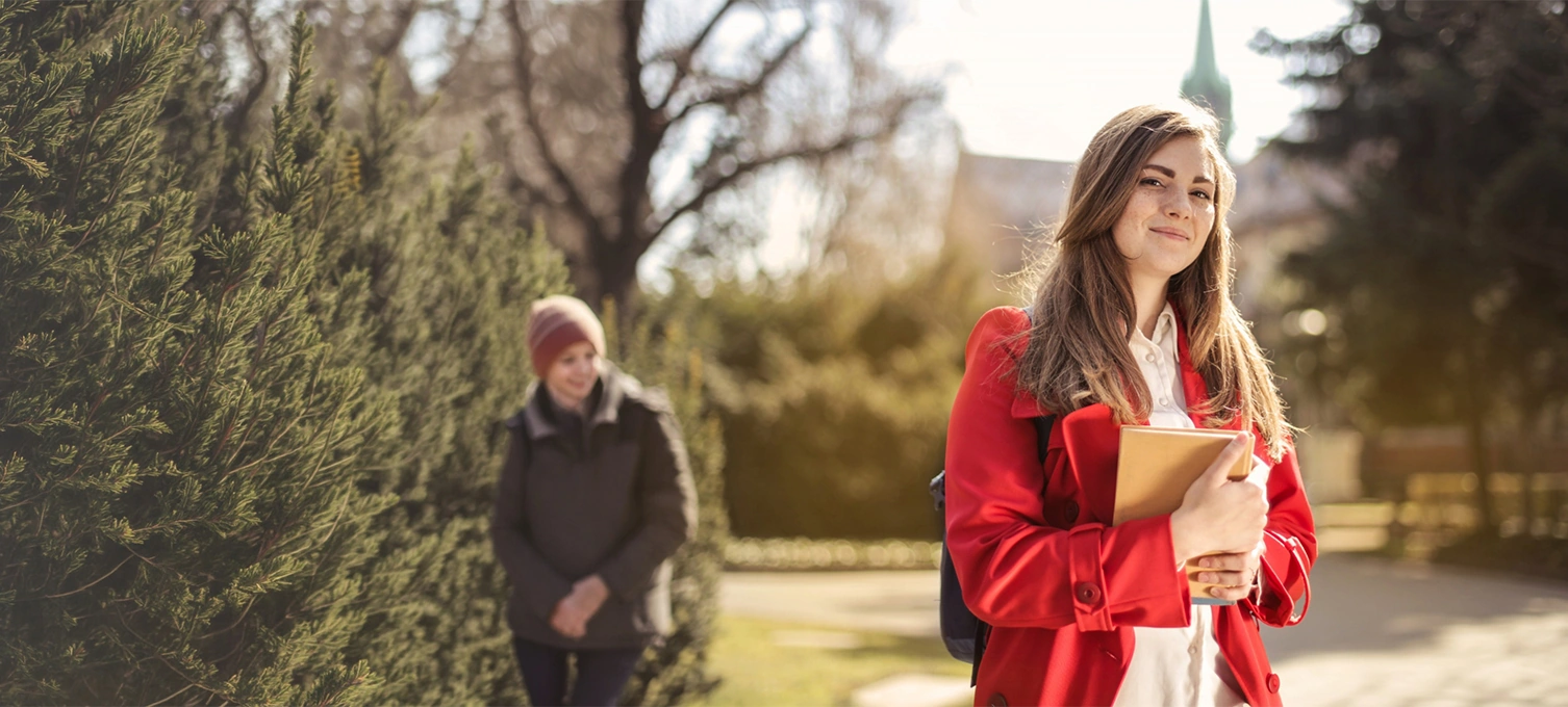 University student holding book on campus